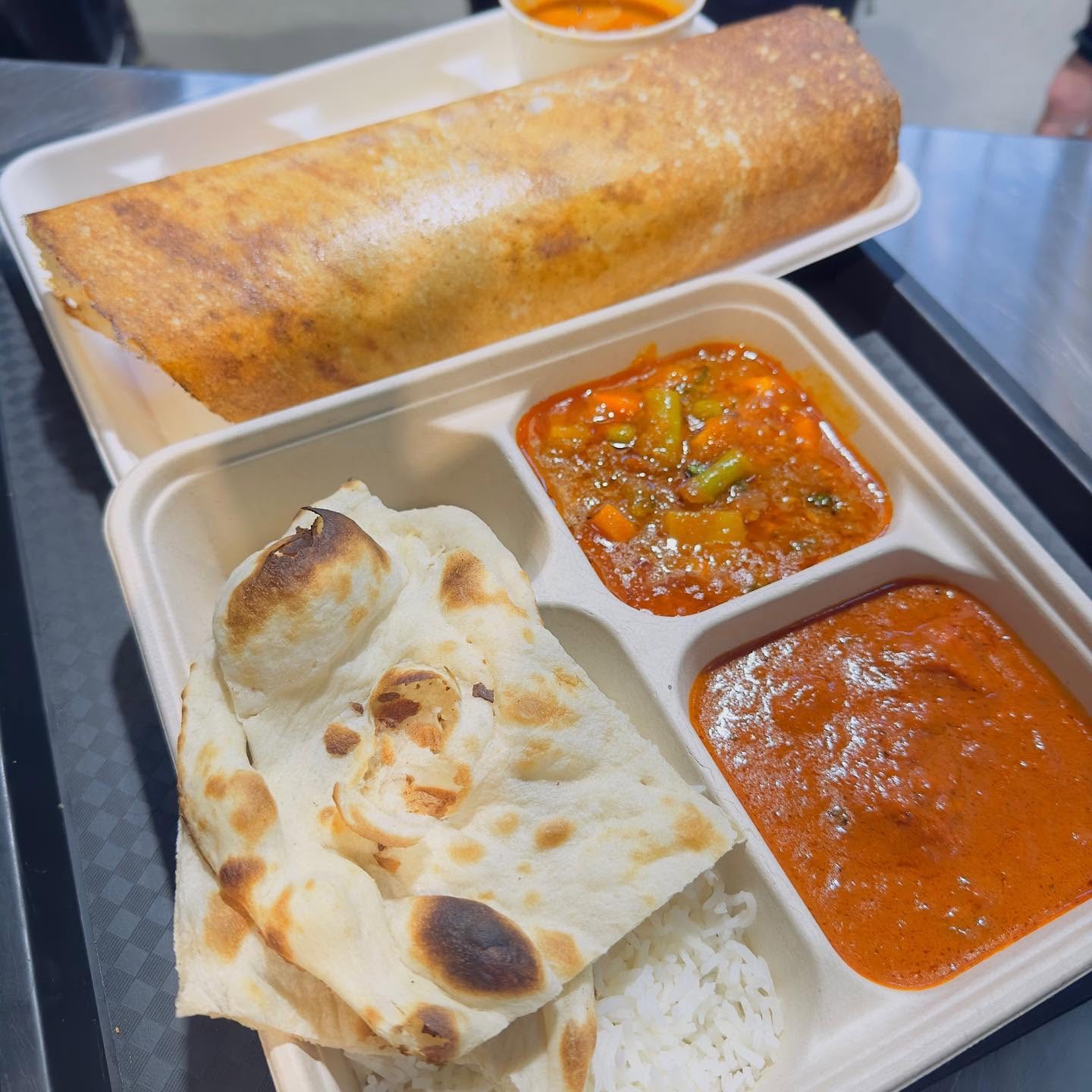 Masala dosa with naan, rice, butter chicken and vegetable curry